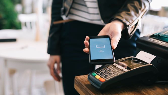 close up of mobile device and POS system